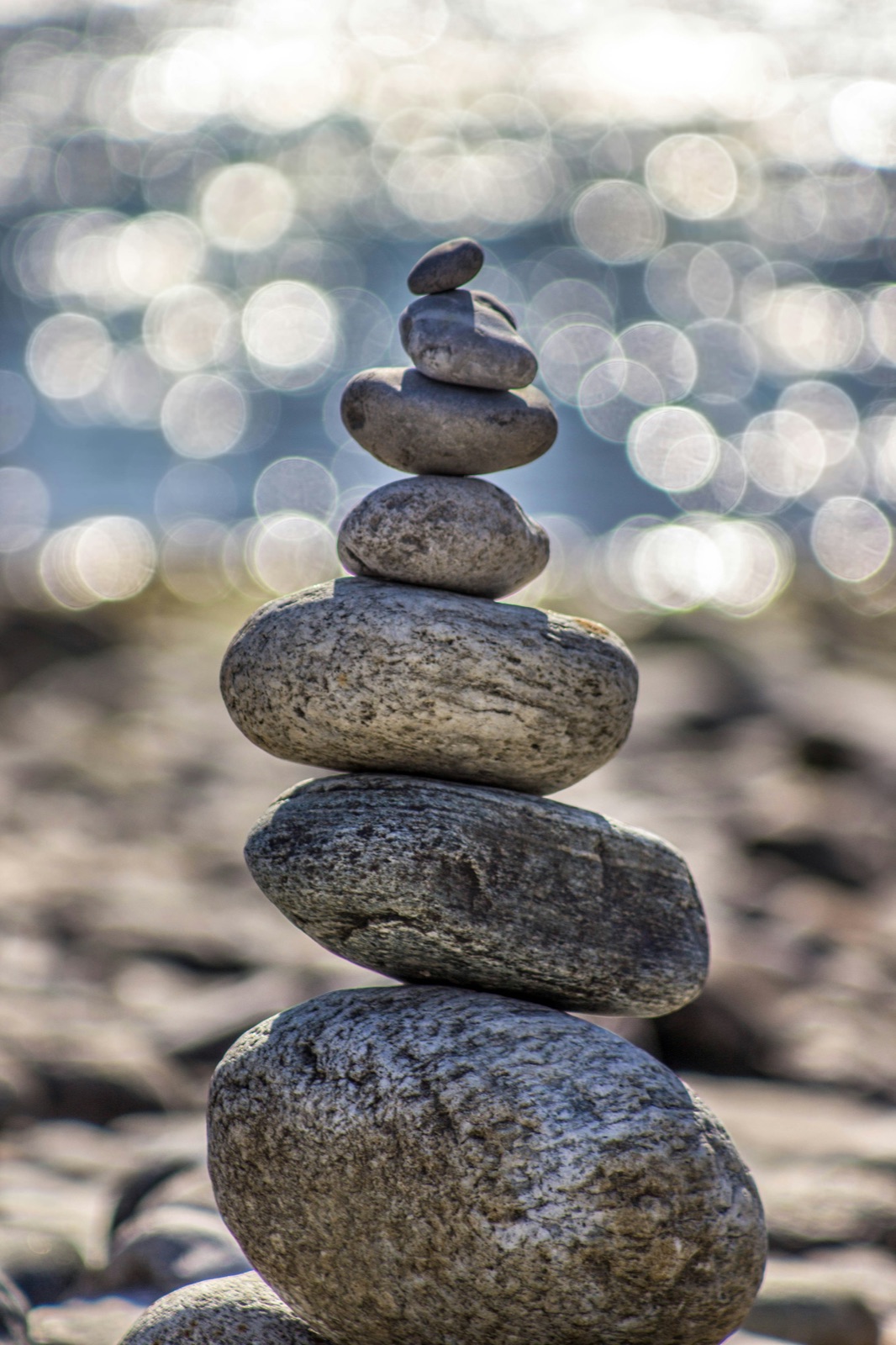 Smooth stones balanced in a stack beside the sea