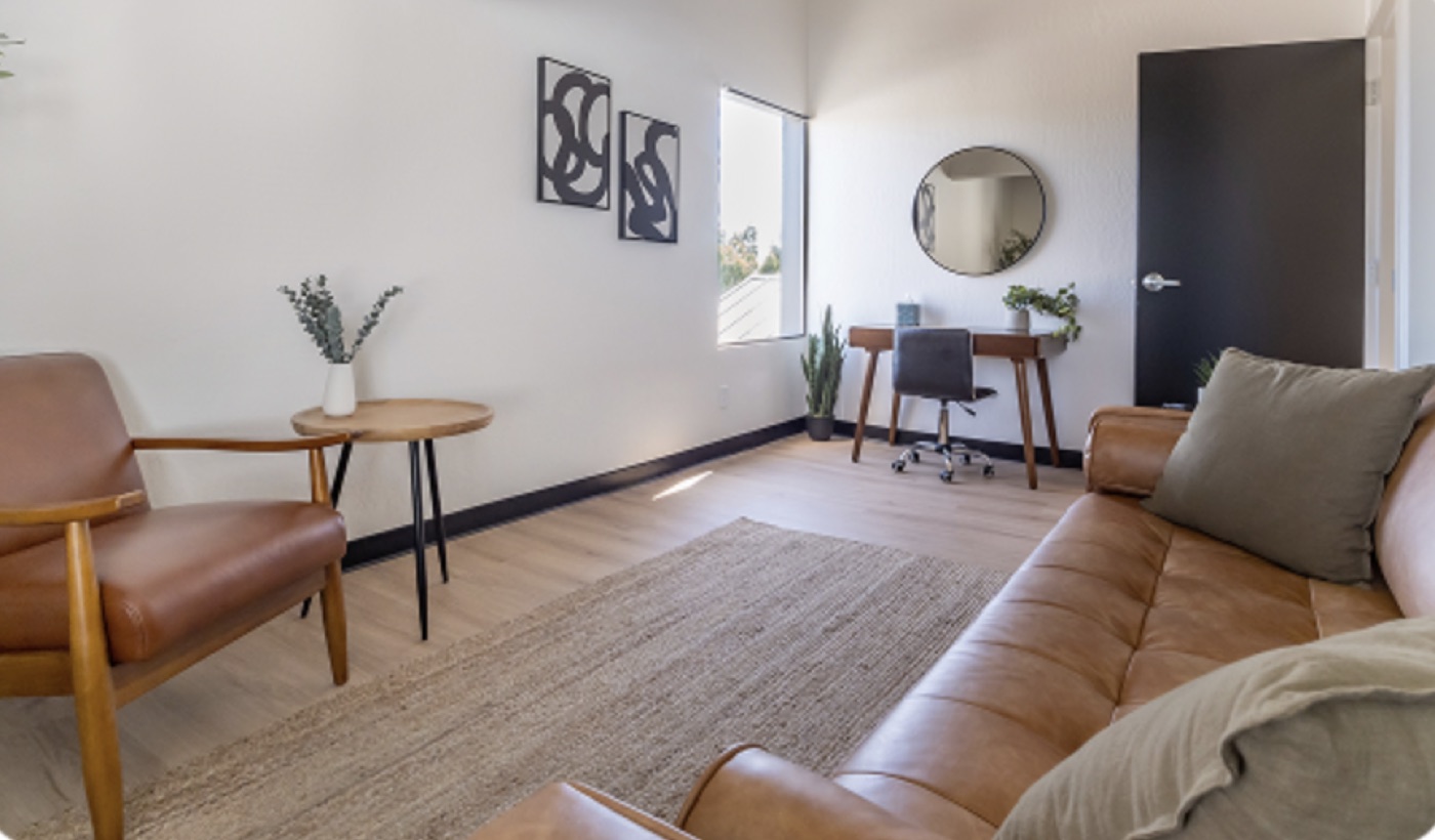Seating area of the therapy office with armchairs and a small desk